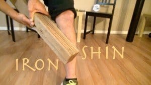 Person holding a wooden board in a room.