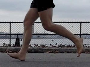 Person walking barefoot near water at a.
