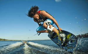 Person wakeboarding on water at sunset.