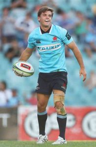 Rugby player with knee injury at game.