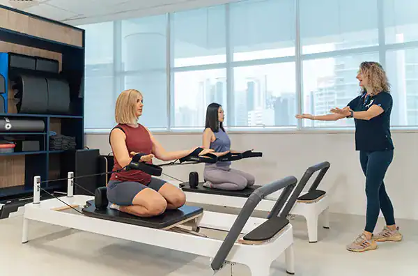 Physiotherapist guides patients in rehab.