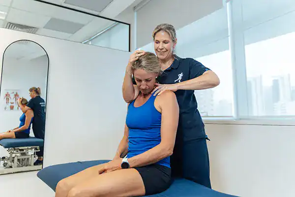 Physiotherapist providing neck massage.