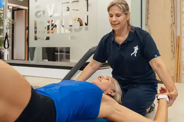 Physiotherapist assisting patient at SP&.