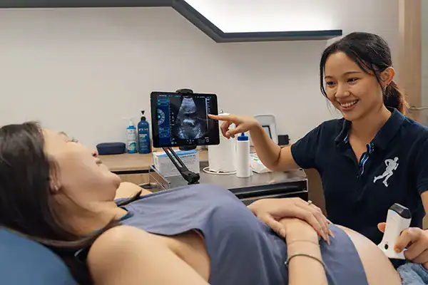 Physiotherapist showing ultrasound scan.