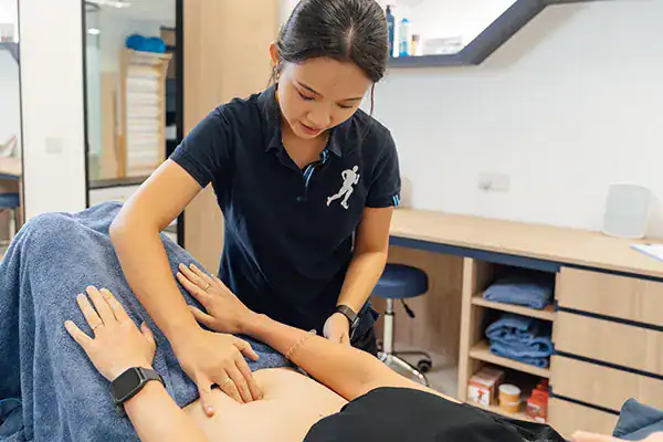 Physiotherapist treating patient's back.