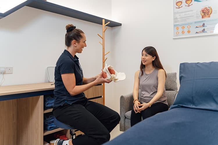 Physiotherapist explaining to patient in.