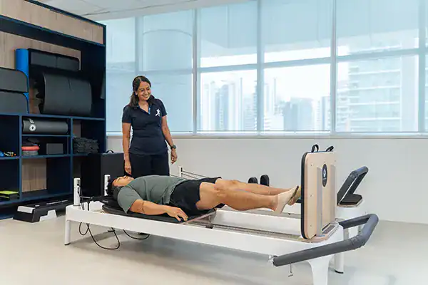 Physiotherapist assisting patient on a T.