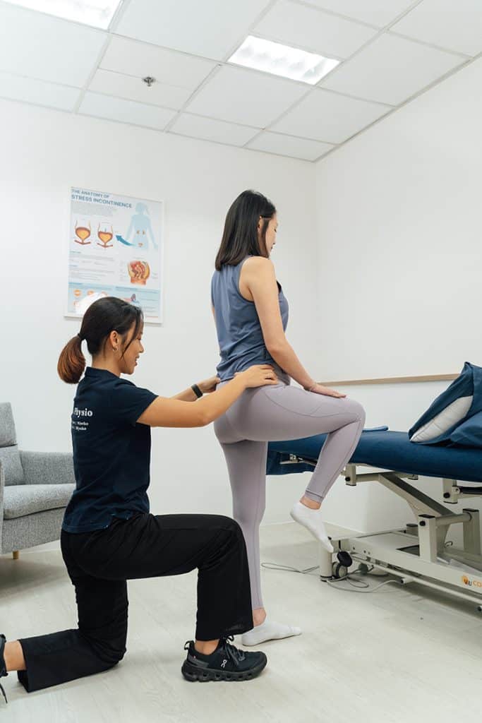 Physiotherapist assisting with hamstring.