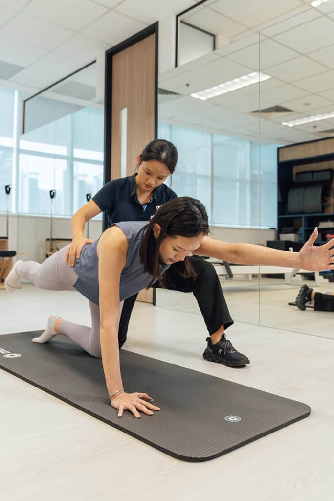 Physiotherapist assisting with back pain.
