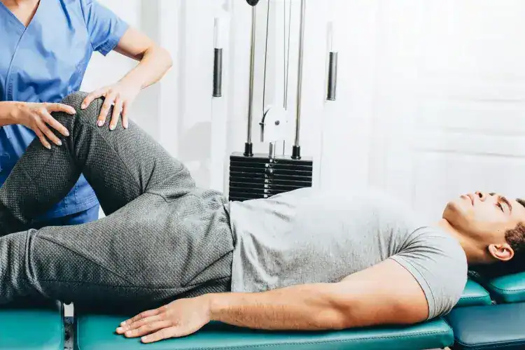 Physiotherapist examining male pelvic.